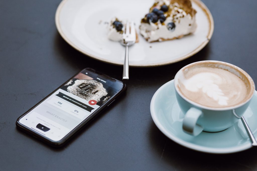 iPhone X on the table in a café - free stock photo