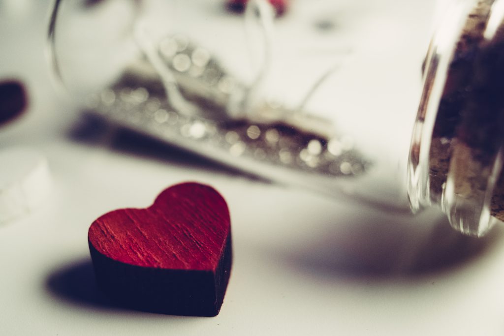 Message in a bottle and a wooden heart - free stock photo