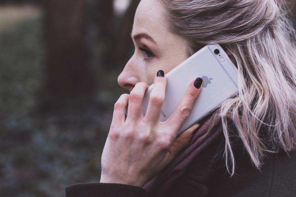 A woman talking on the phone closeup - free stock photo