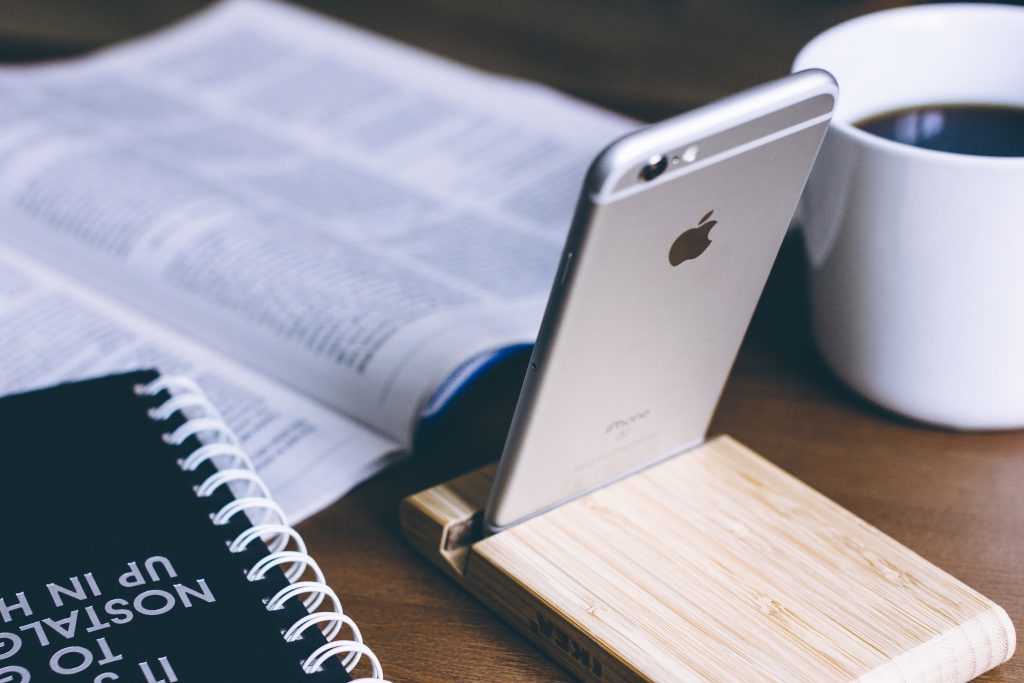 iPhone in a wooden phone holder 2 - free stock photo