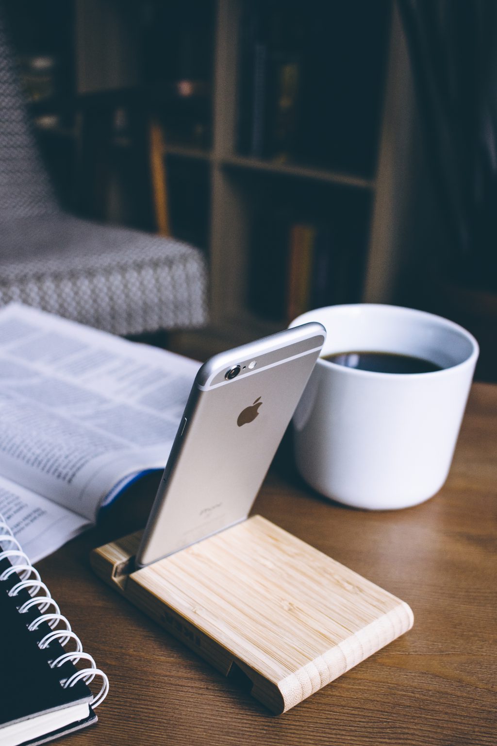 iPhone in a wooden phone holder 3 - free stock photo