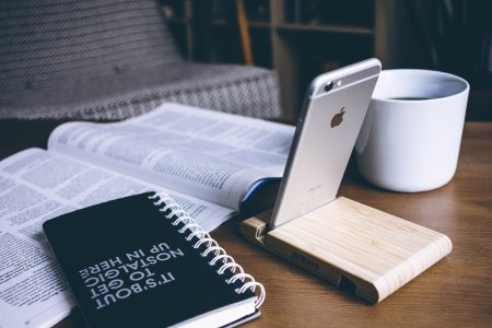 iPhone in a wooden phone holder 4 - free stock photo