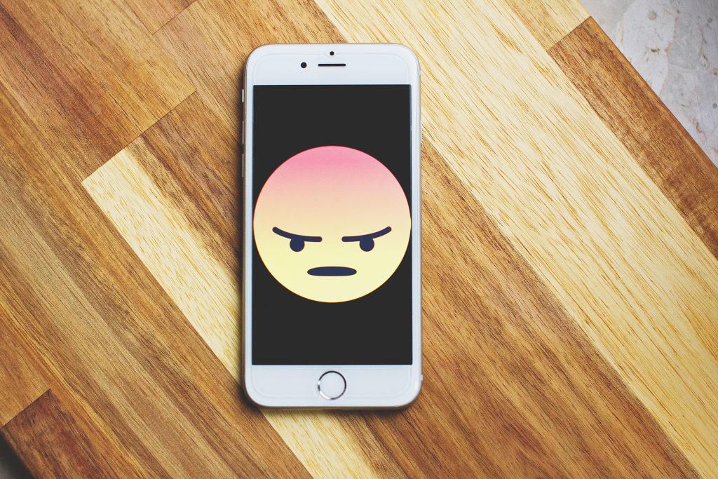 Angry face emoticon on iPhone - free stock photo
