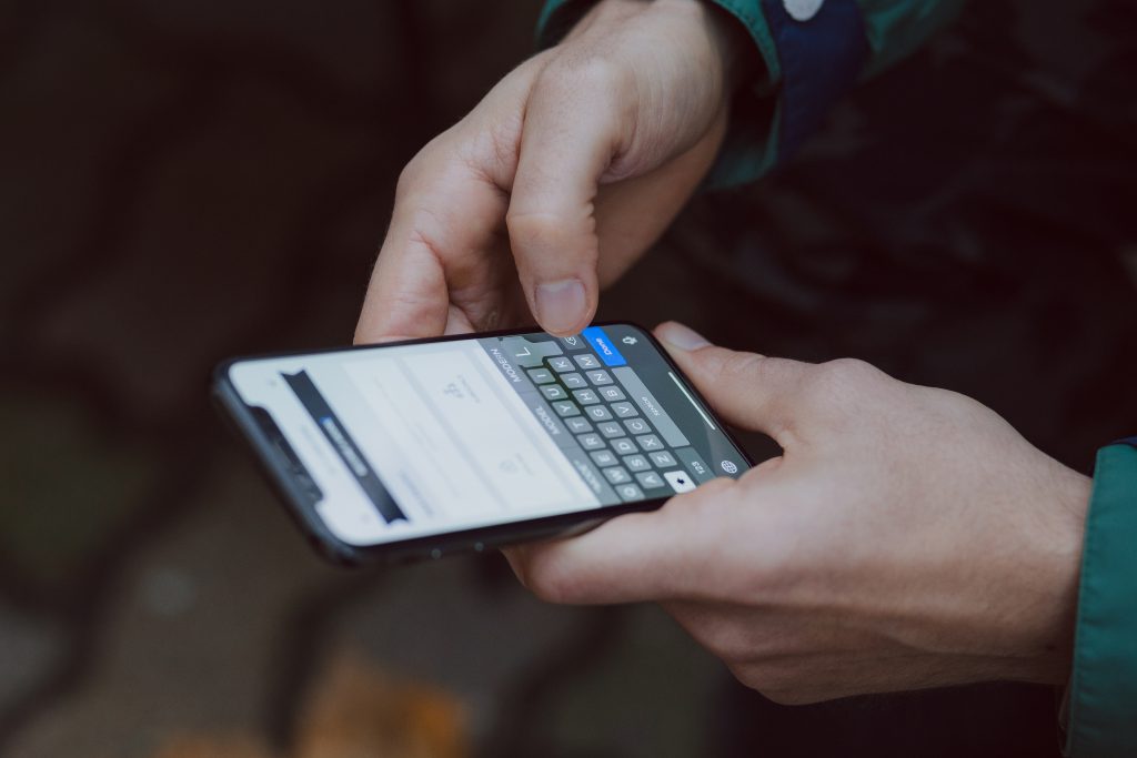 Male holding an iPhone X 2 - free stock photo