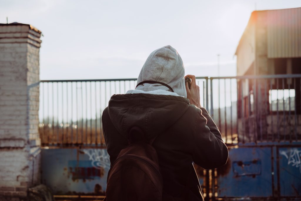 Male photographer shooting an old warehouse - free stock photo