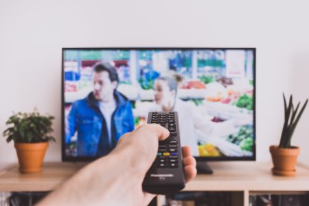 Remote control pointed at a TV screen 2 - free stock photo