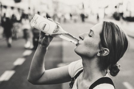 Female drinking soda from a glass bottle - free stock photo