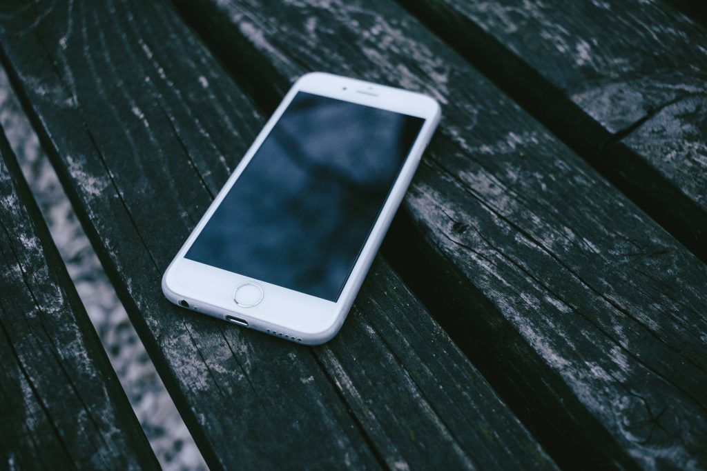 iPhone on a wooden bench - free stock photo