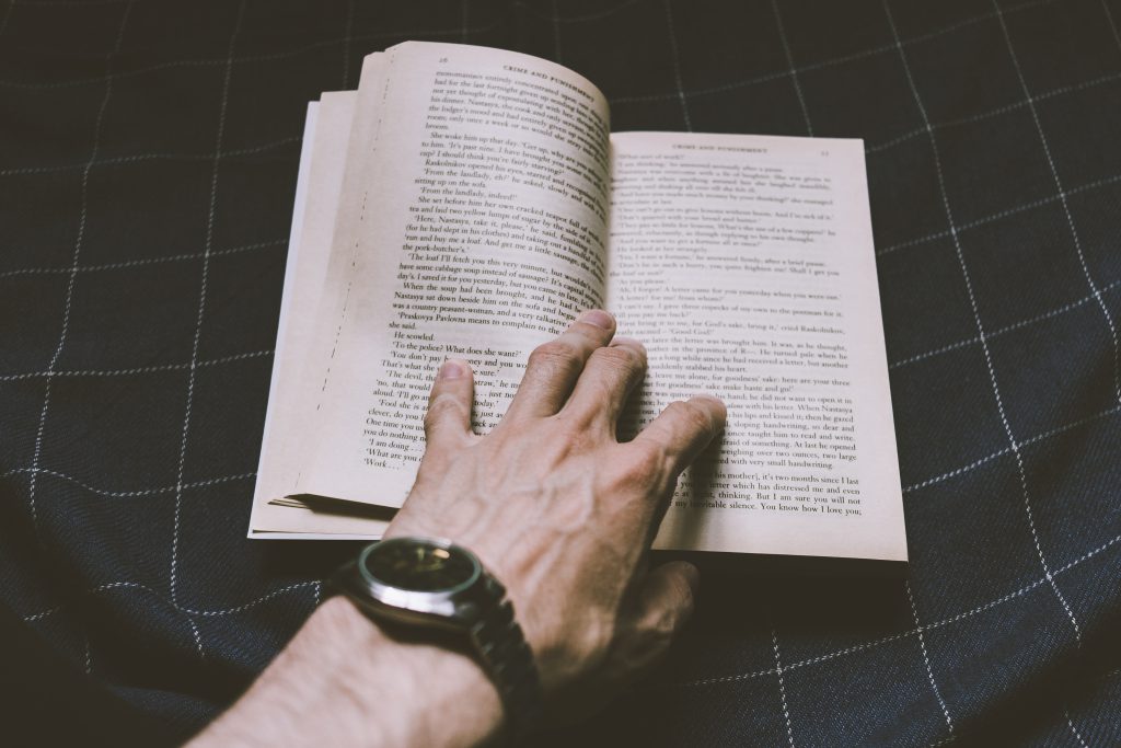 male_hand_holding_an_open_book-1024x683.jpg