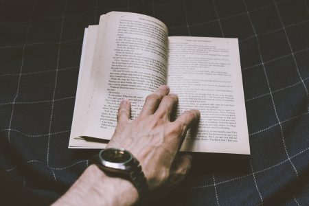 Male hand holding an open book - free stock photo