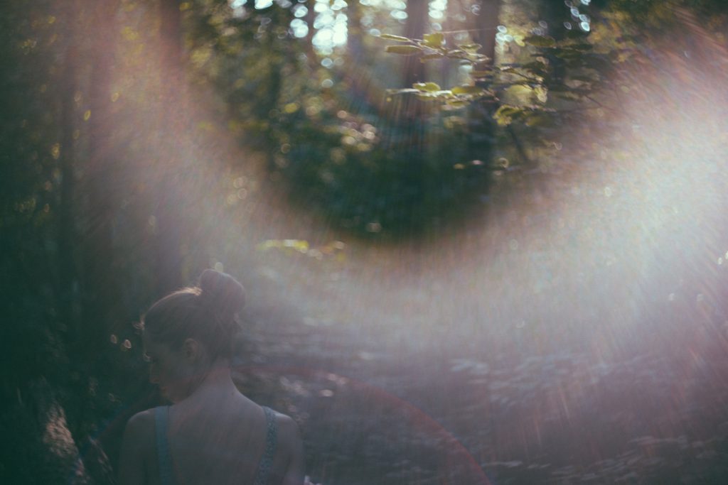 Helios shot of a girl with a sunflare - free stock photo