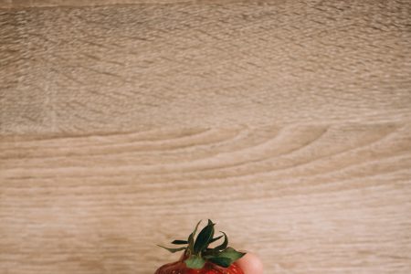 Strawberry in a male hand - free stock photo