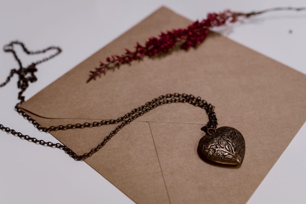 Heart necklace on a craft envelope - free stock photo