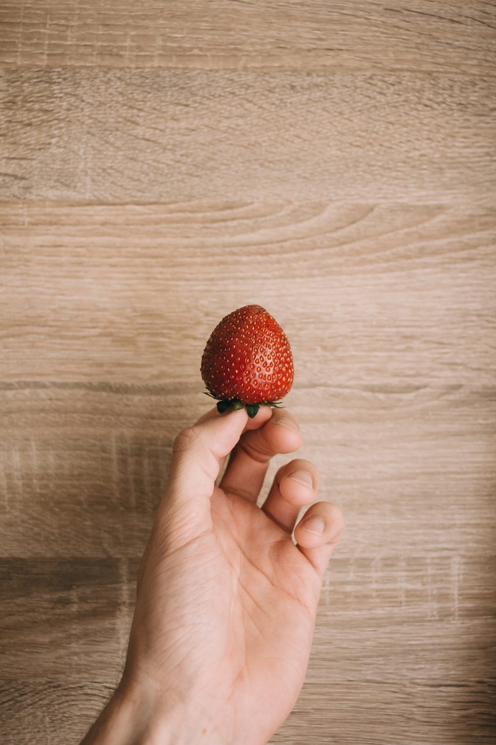 Strawberry in a male hand 2 - free stock photo
