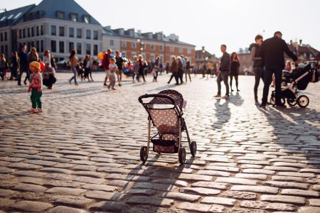 An empty stroller in a crowded Old Town square - free stock photo