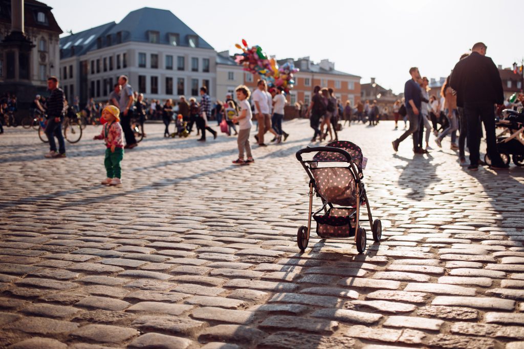 An empty stroller in a crowded Old Town square 3 - free stock photo