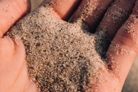 Sea beach sand in a hand closeup - free stock photo