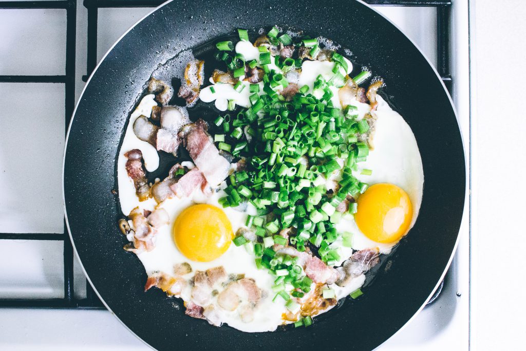 Eggs, bacon and chive on the frying pan - free stock photo
