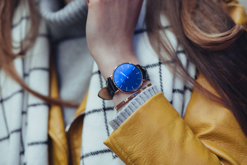 female black and gold wristwatch