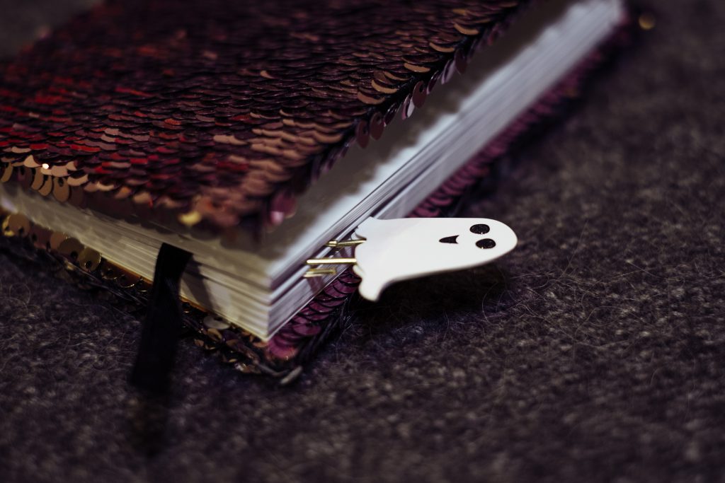 A ghost paperclip in a notebook - free stock photo