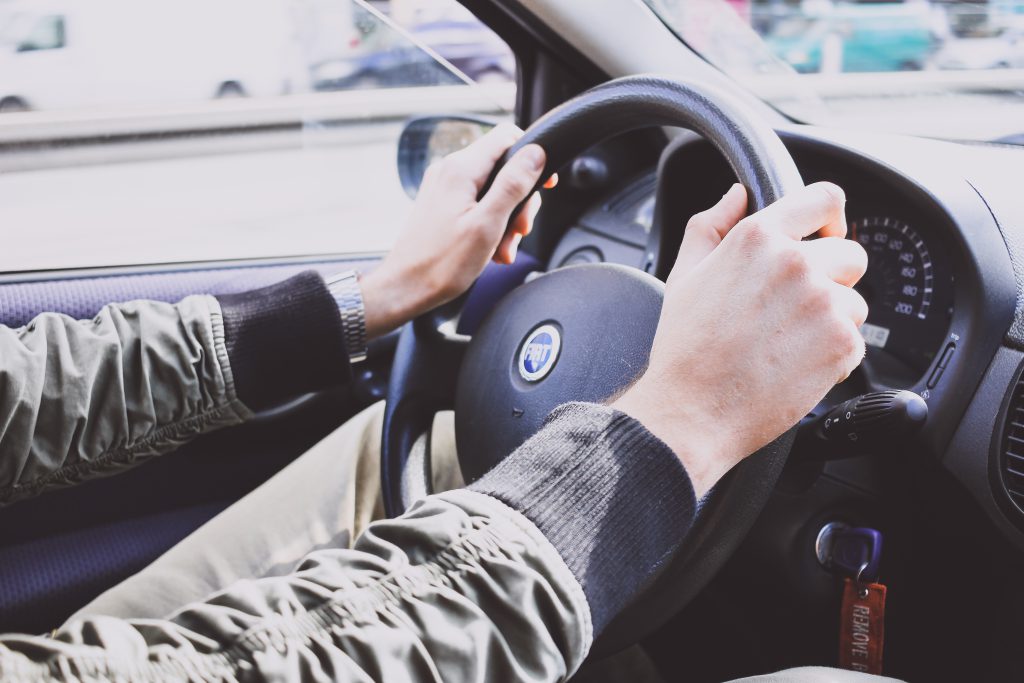 Male hands on a car steering wheel - free stock photo