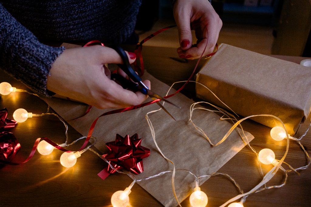Female decorating a gift - free stock photo