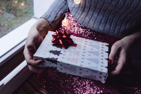 A female holding a christmas gift - free stock photo