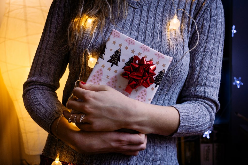A female holding a christmas gift 4 - free stock photo