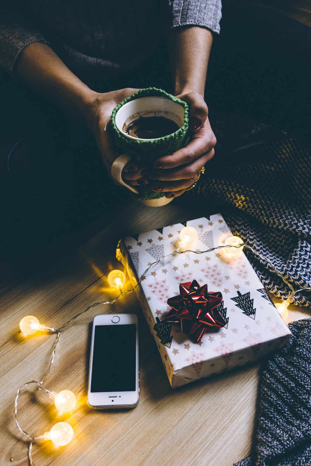 A female holding a mug in a festive setting - free stock photo