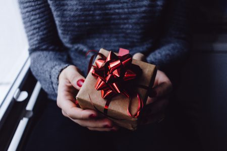 A female holding a wrapped gift - free stock photo