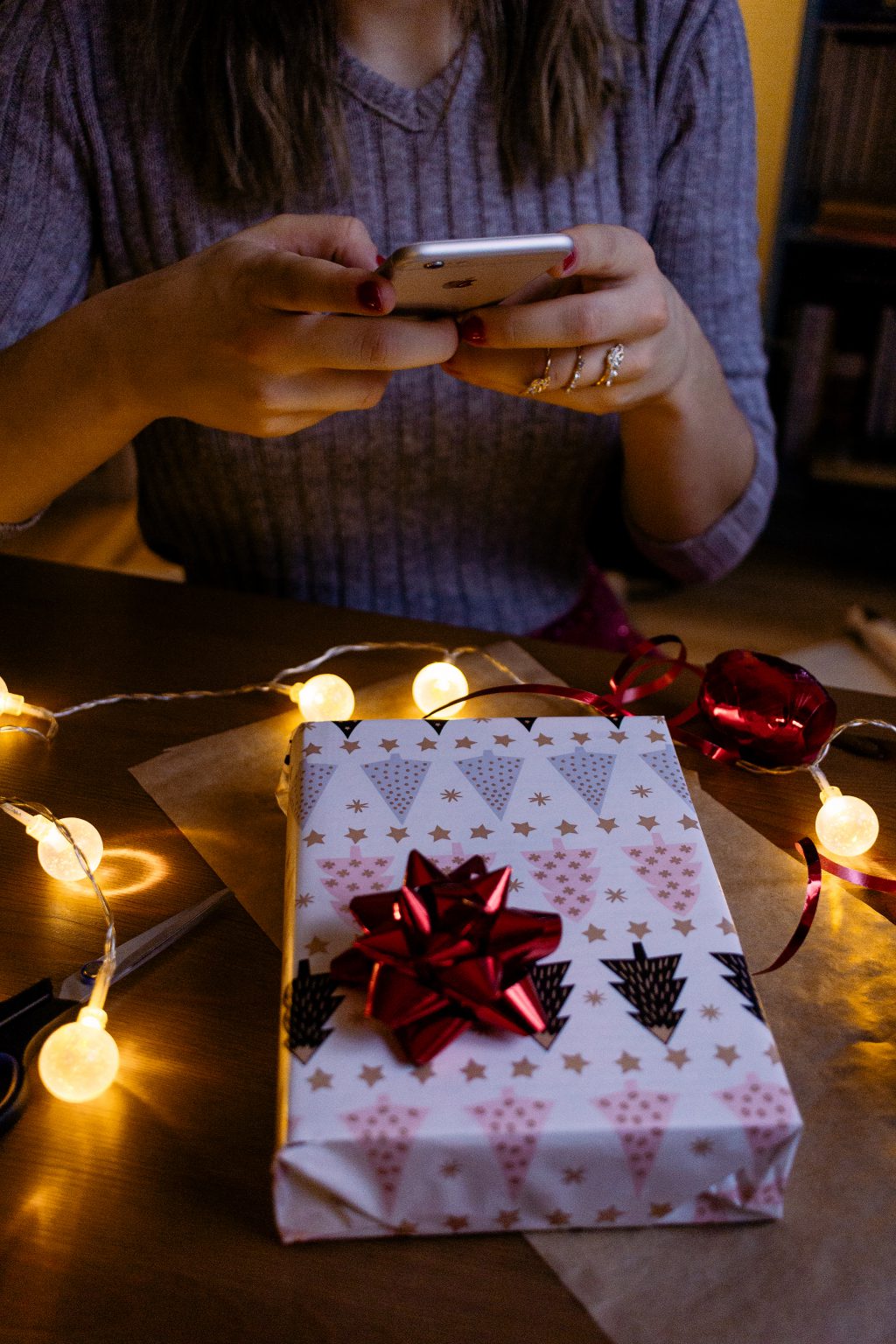 A female taking picture of a christmas gift 2 - free stock photo