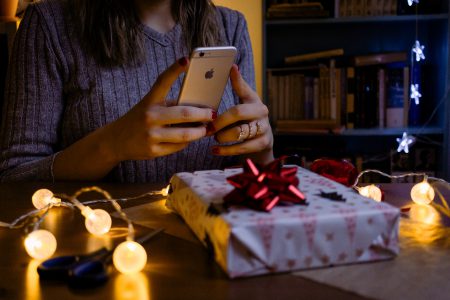 A female taking picture of a christmas gift 3 - free stock photo