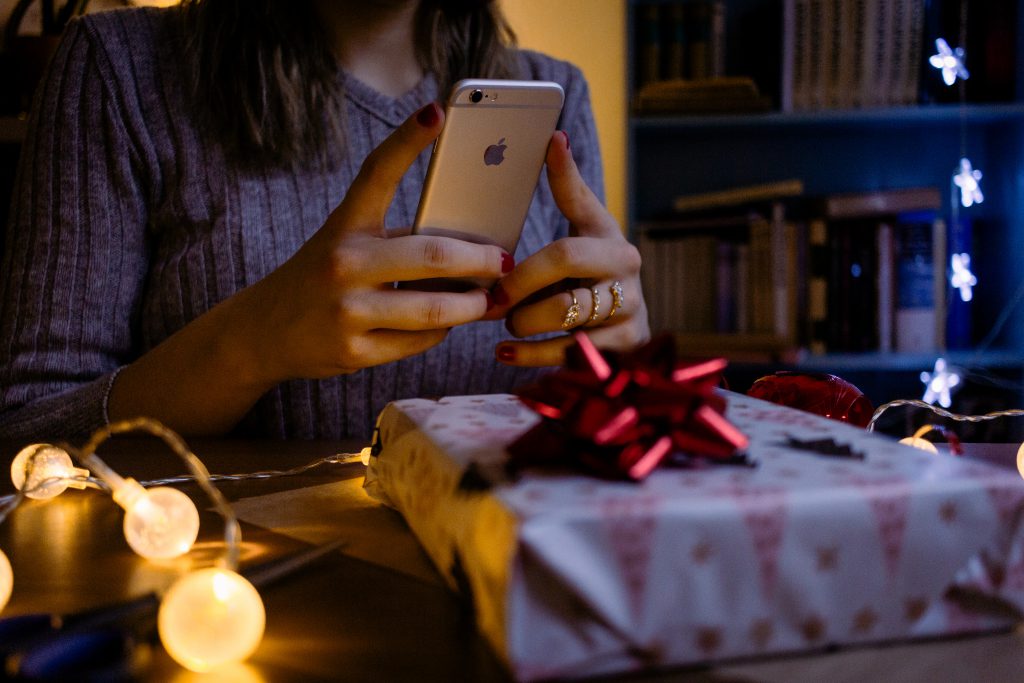 A female taking picture of a christmas gift 4 - free stock photo