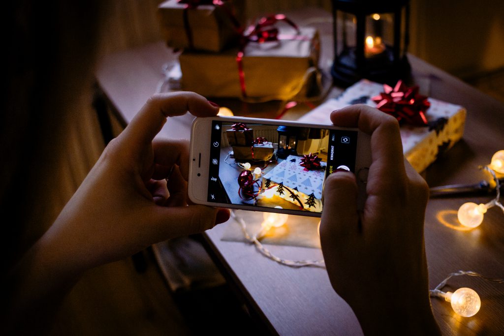 A female taking picture of a christmas gift 5 - free stock photo