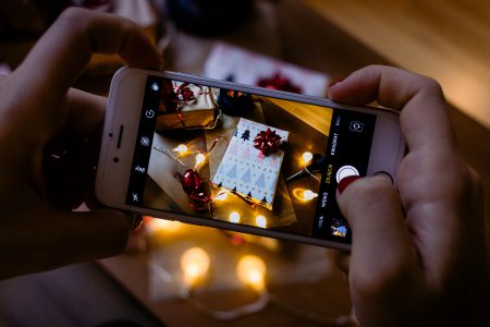 A female taking picture of a christmas gift 6 - free stock photo