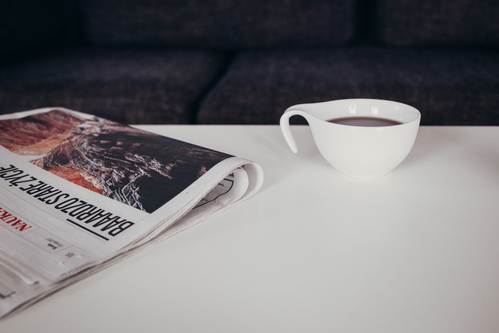 cup_of_coffee_and_a_newspaper_on_the_tab