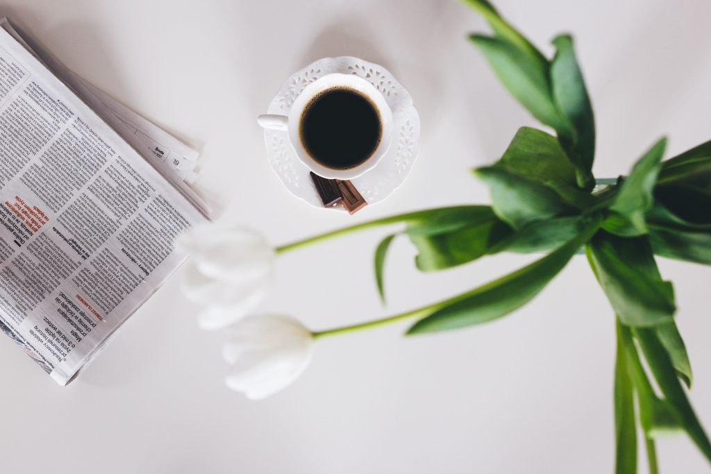 Cup of coffee and a newspaper on the table 4 - free stock photo
