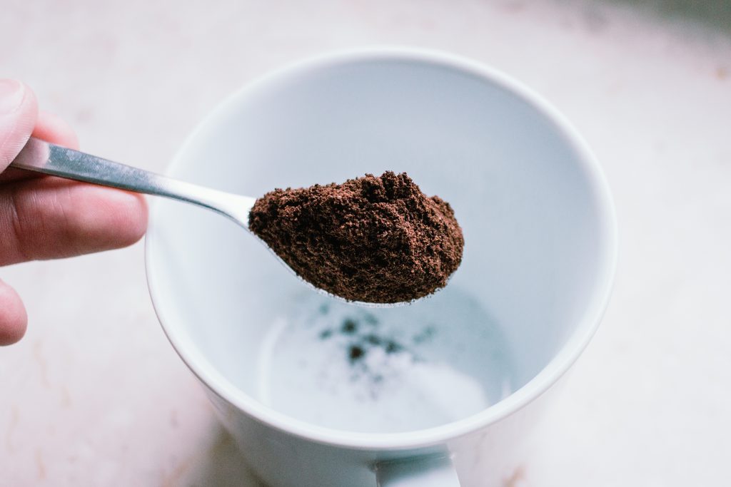 Ground coffee in a spoon - free stock photo