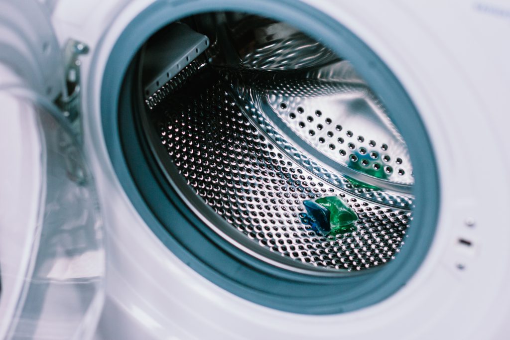 Laundry detergent pod inside a washing machine - free stock photo