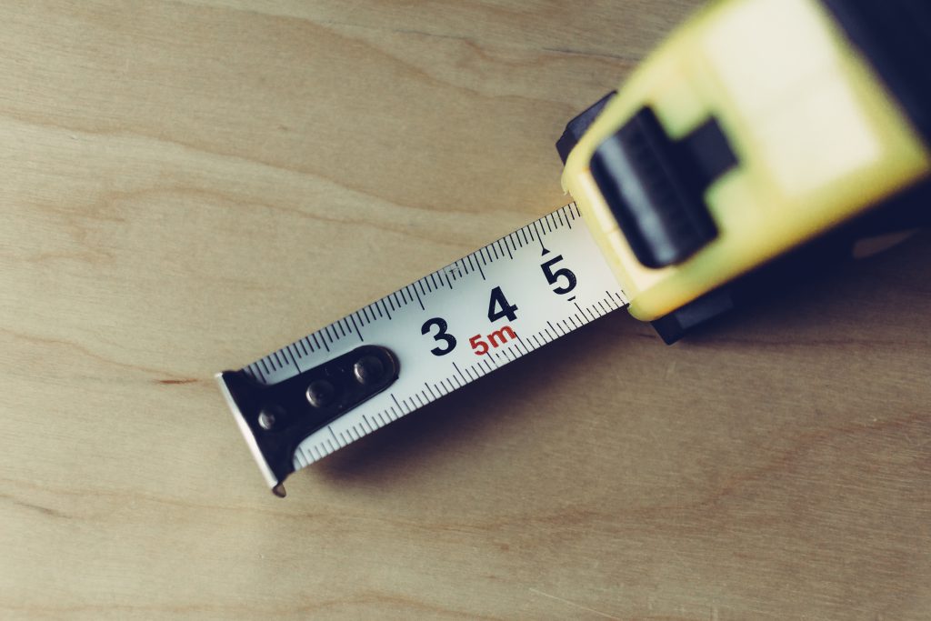 Metal tape measure tool closeup - free stock photo