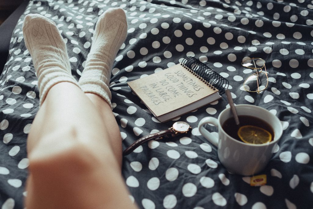 Chilling in bed in woollen socks - free stock photo