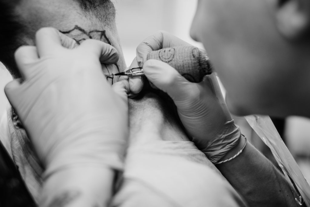 Tattoo artist at work 4 - free stock photo