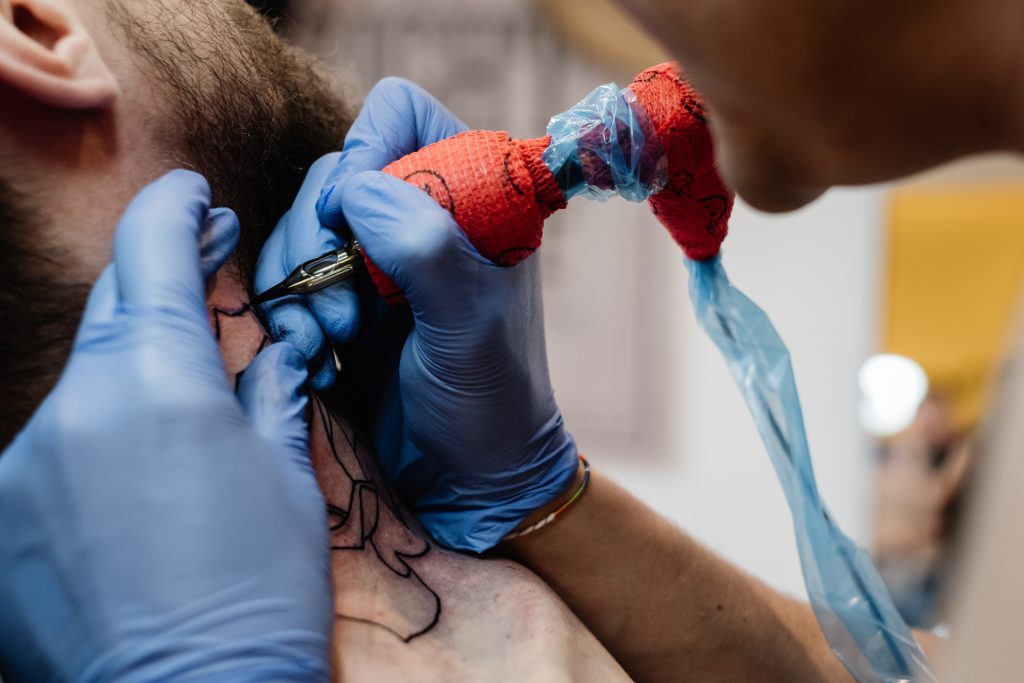 Tattoo artist at work closeup 2 - free stock photo