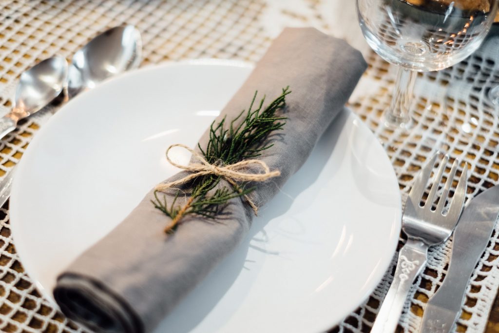 Linen napkin decorated with a conifer twig - free stock photo