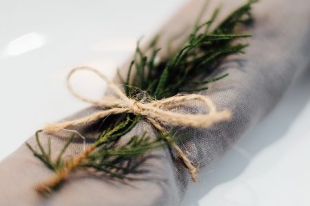 Linen napkin decorated with a conifer twig closeup - free stock photo