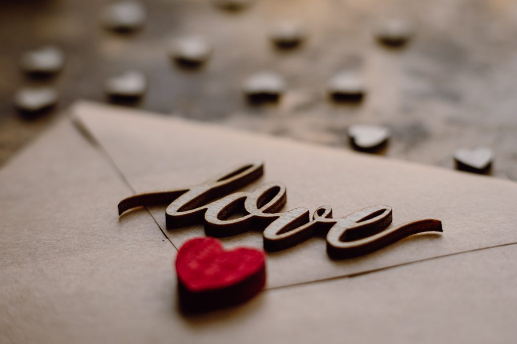 Wooden word love on a beige envelope - free stock photo