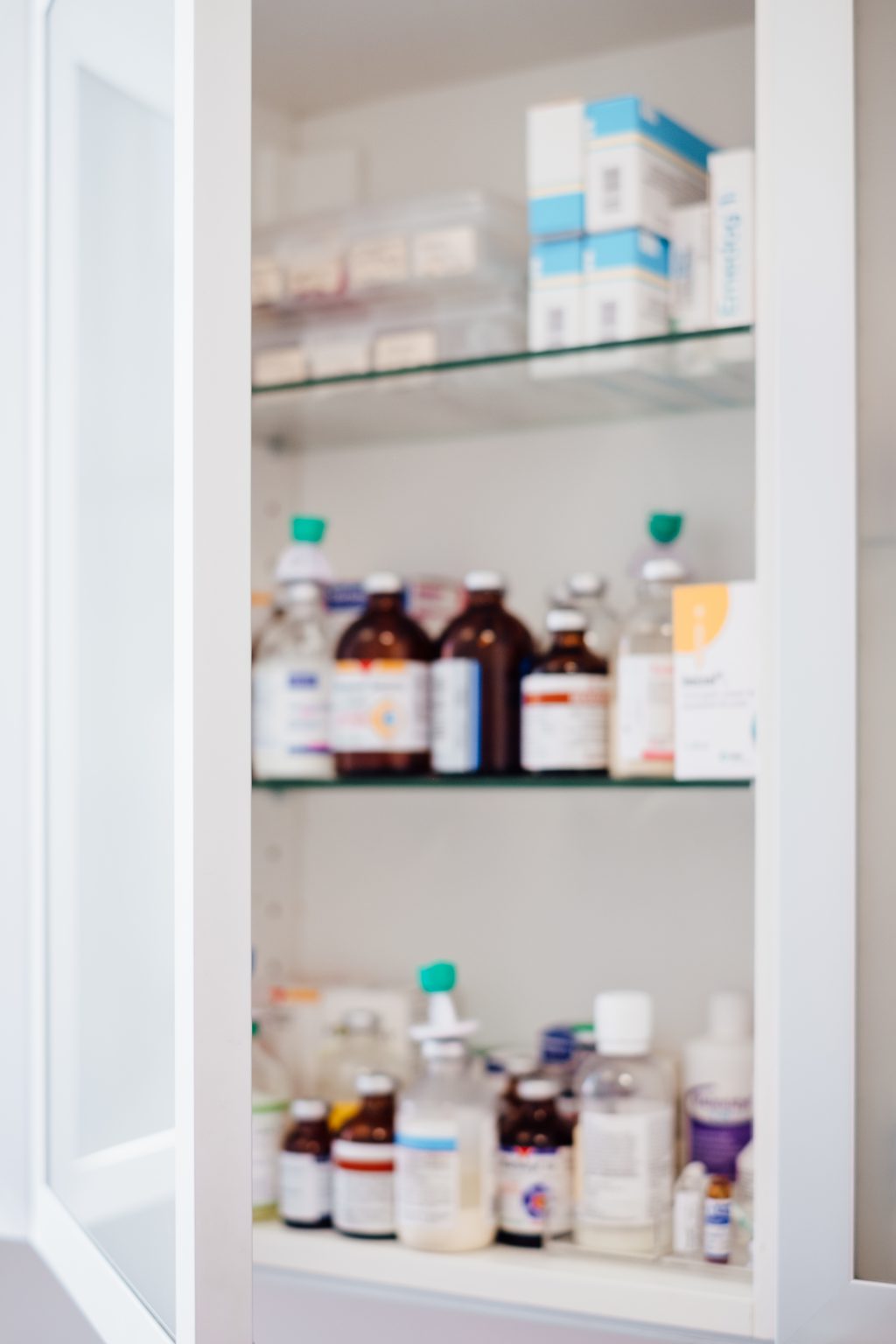 Medicine bottles and pills on shelves - free stock photo