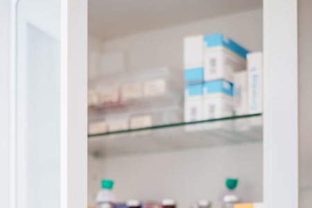 Medicine bottles and pills on shelves - free stock photo