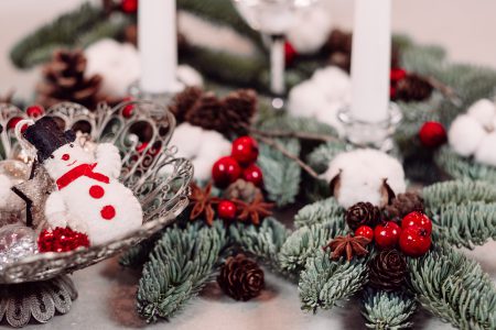 Christmas spruce decoration with candles and a snowman - free stock photo