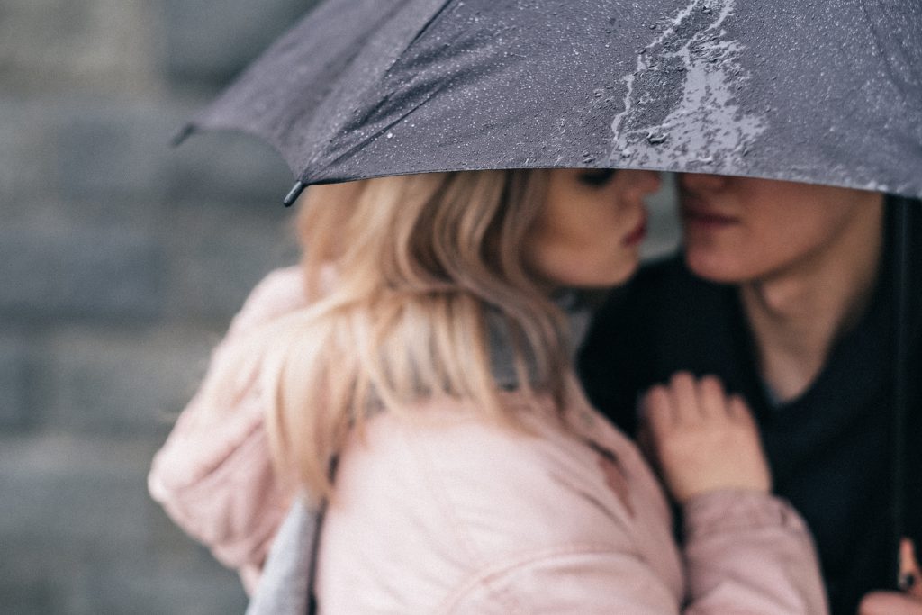 A couple hugging under an umbrella closeup 2 - free stock photo